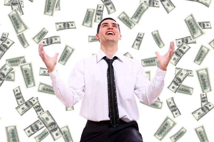 happy-businessman-and-flying-dollar-banknotes-scaled